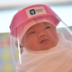 Illustration for article titled Heres a Slightly Crotchety Baby In the Tiniest PPE Youve Ever Seen